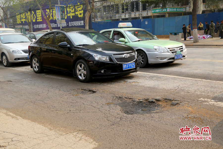 南陽(yáng)路上汽車(chē)?yán)@坑而行