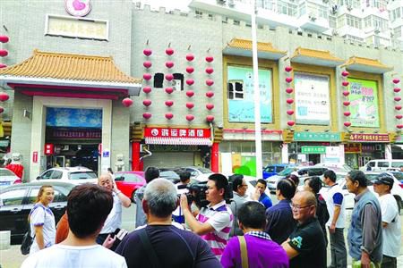 青島宰客海鮮店成“景點”，游人“參觀”拍照。