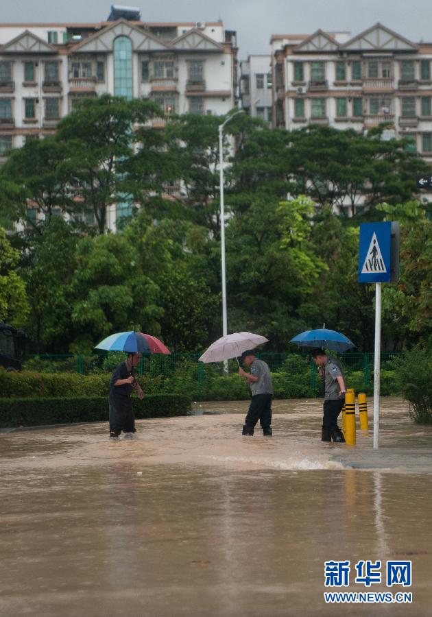 5月11日，人們在深圳西麗涉水行走。