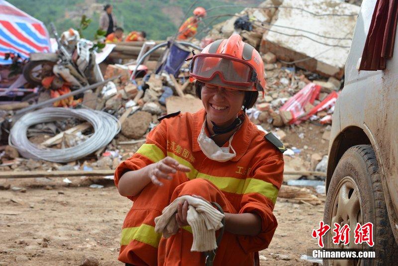 2014年8月5日，女兵在云南魯?shù)辇堫^山鎮(zhèn)廢墟中搜救被困者。