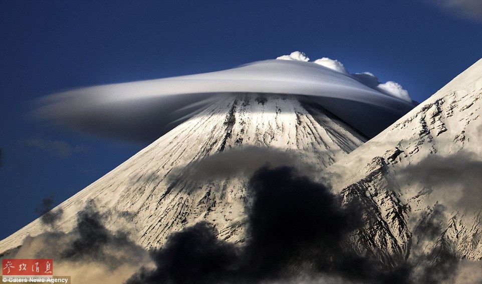 火山上籠罩著類似于外星飛碟形狀的云彩，場景猶如科幻大片。